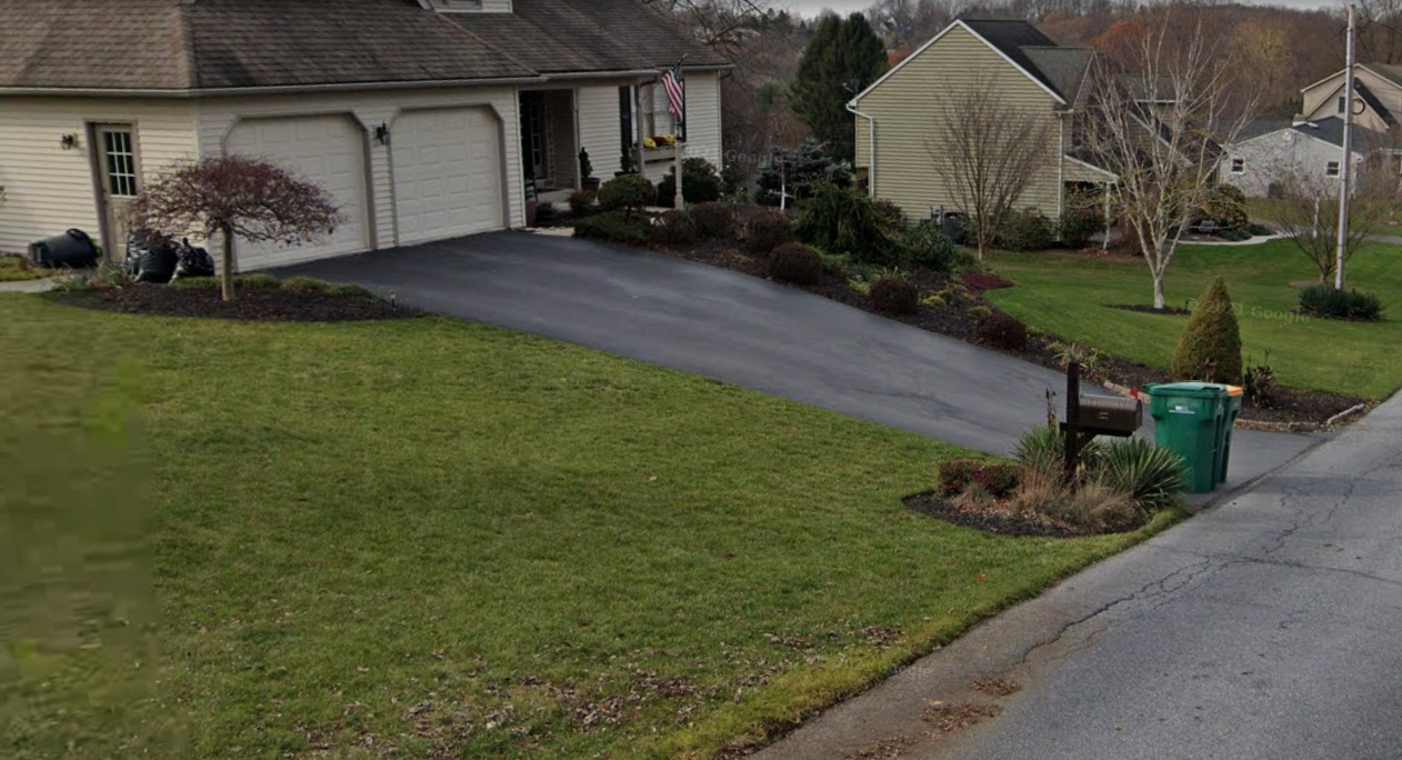 Driveway with a very steep drop-off to the road.
