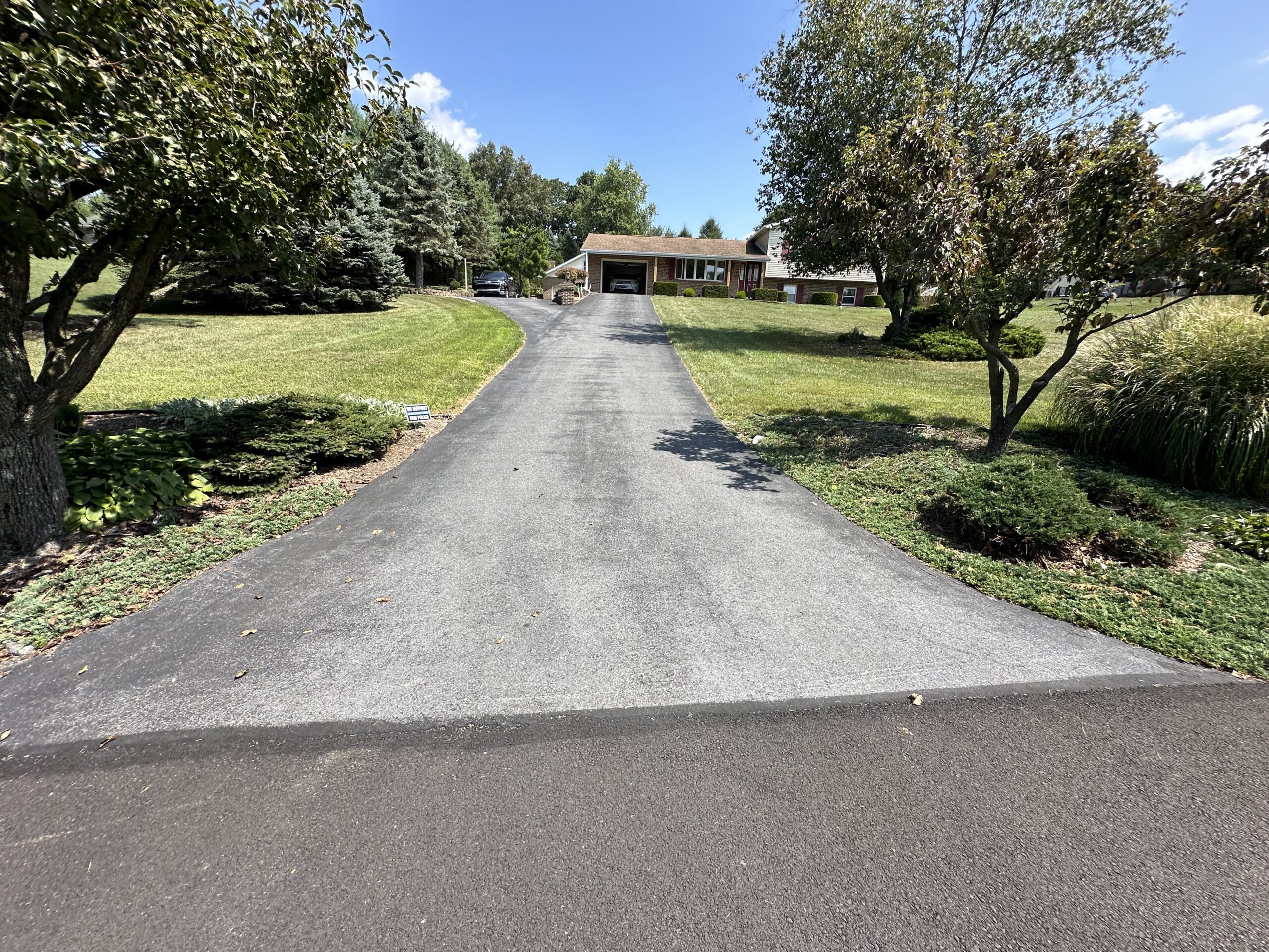 Long, grey asphalt driveway. Middletown.