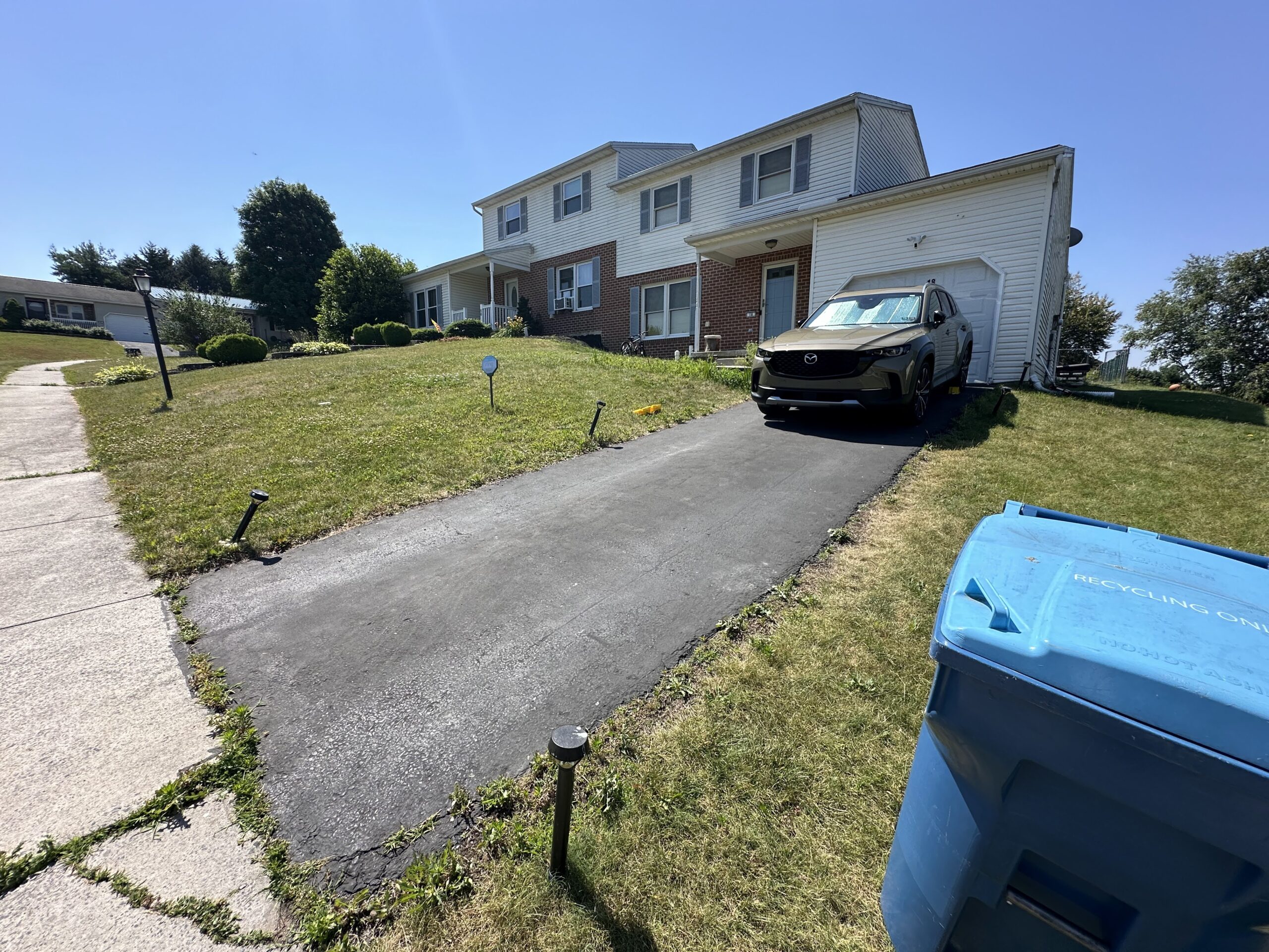 Severely cracked, rutted, and damaged driveway. Residential project in Mechanicsburg.