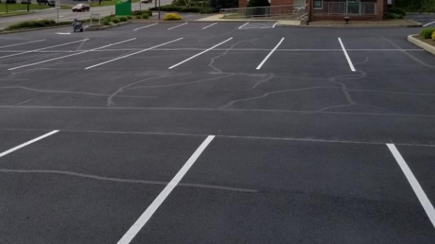 A parking lot that has been crack filled, sealcoated, and line striped.