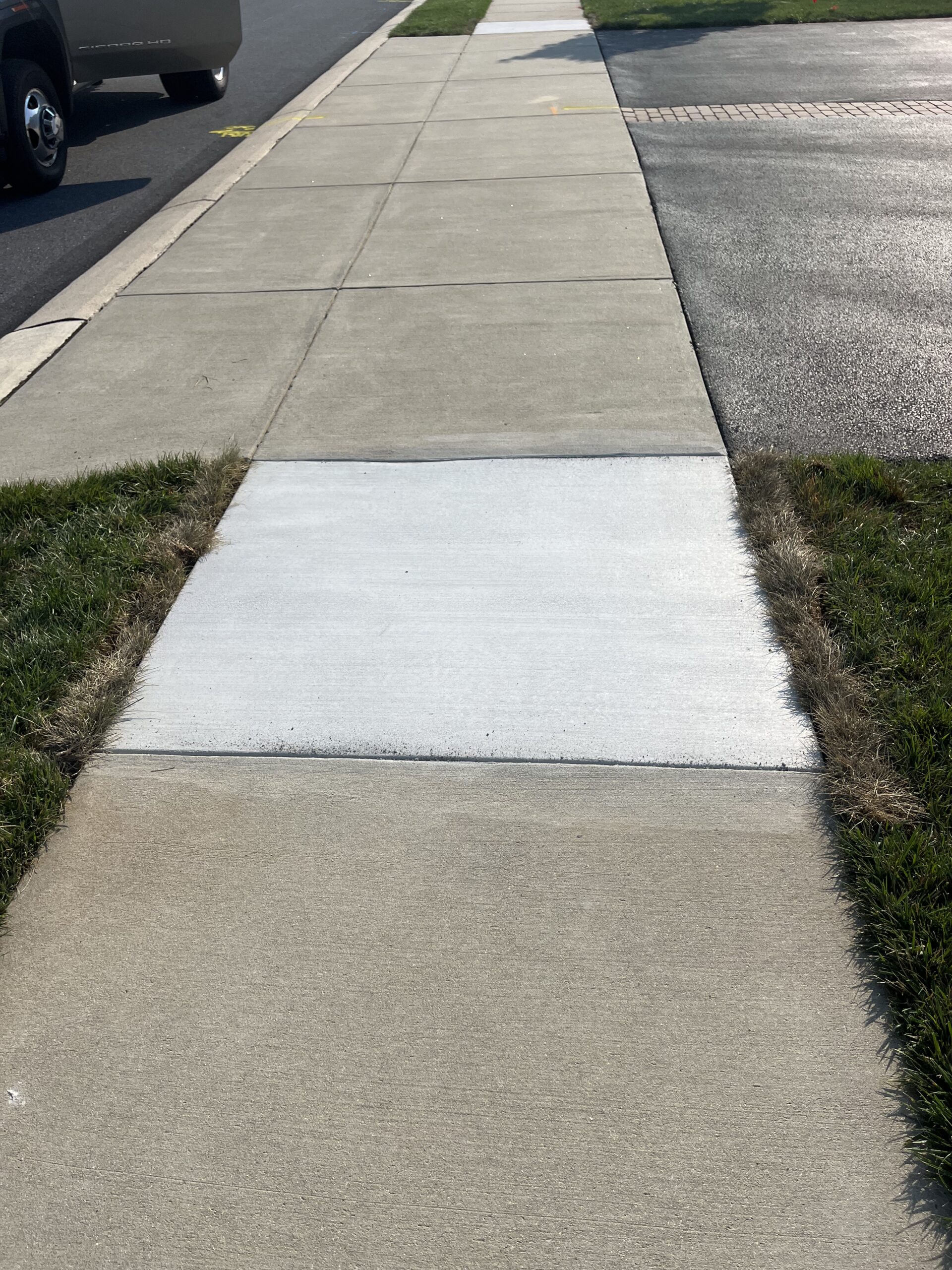 A cured, broom-finished section of concrete that our team replaced.